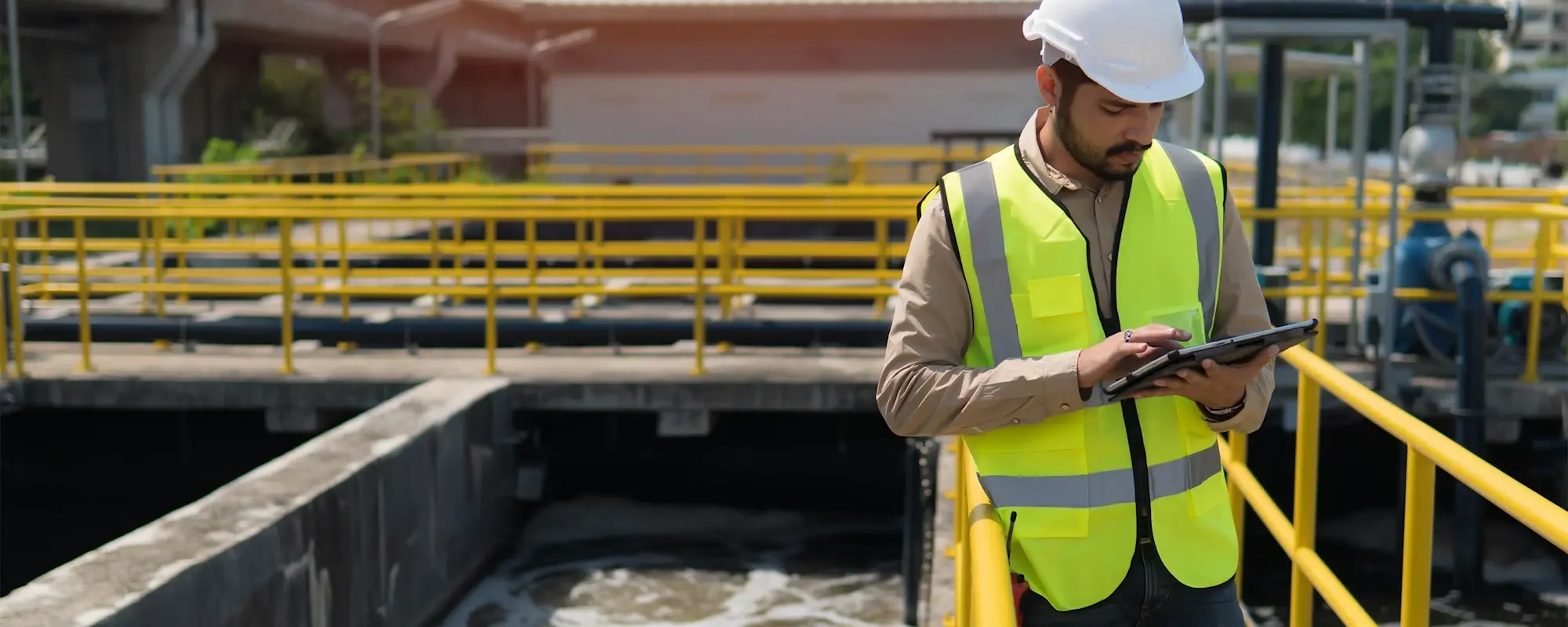 Field worker using a tablet at a water treatment facility